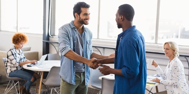 Two volunteers shaking hands.