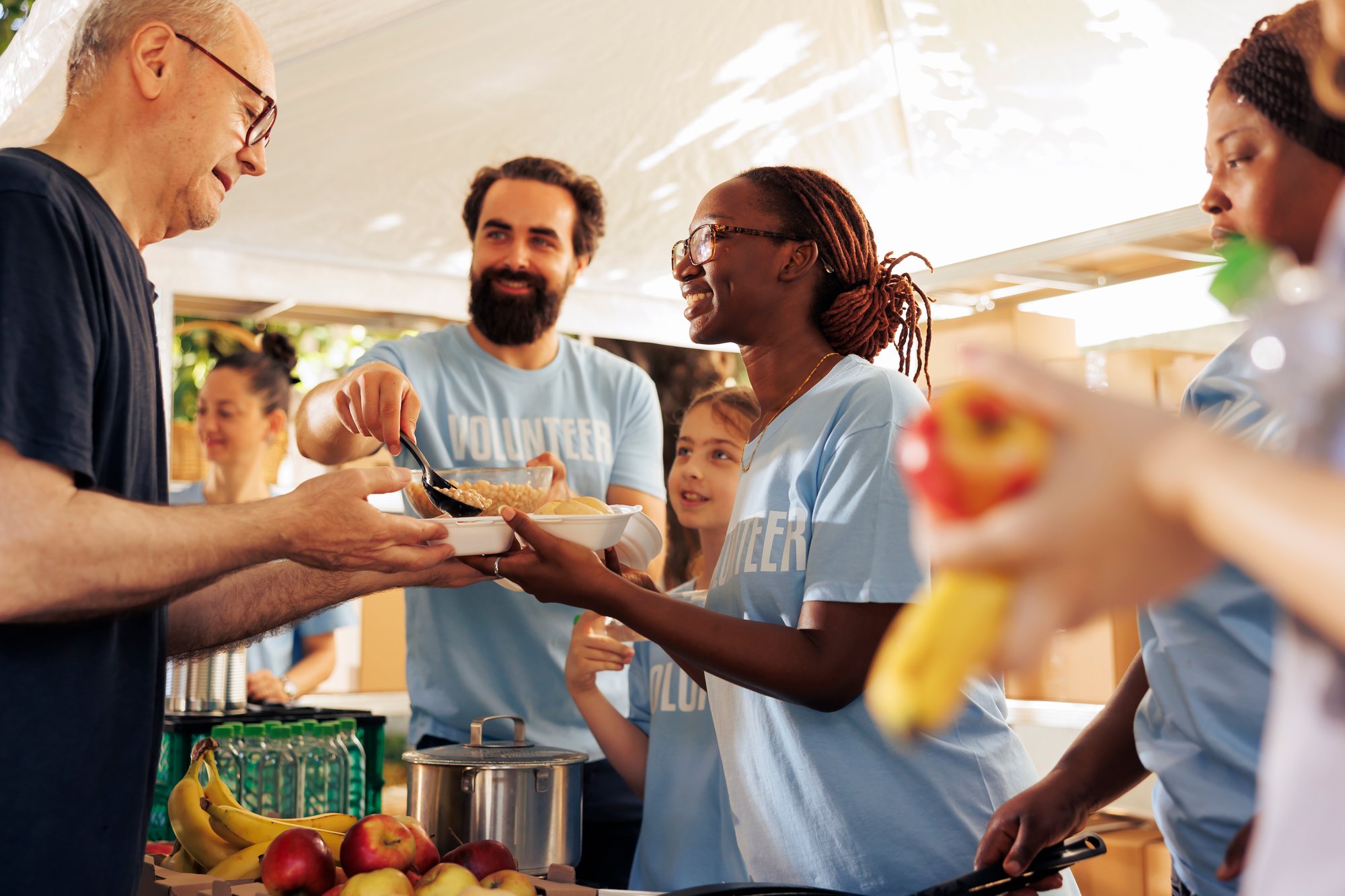 friendly-volunteers-serve-food-at-outdoor-event-2026-03-19-01-46-27-utc