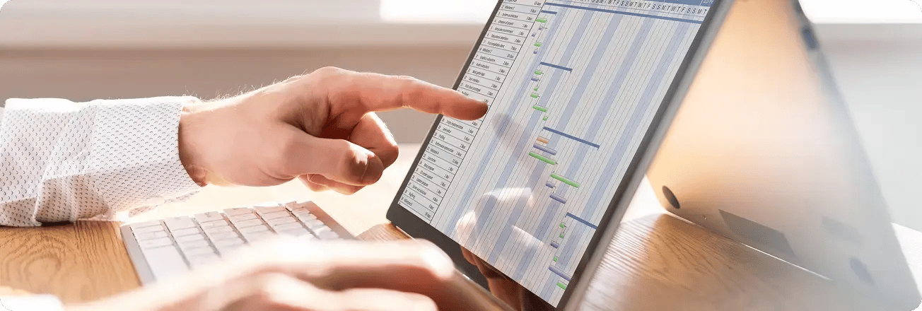 Close-up of a person using a tablet with scheduling software displayed, highlighting volunteer tracking features.